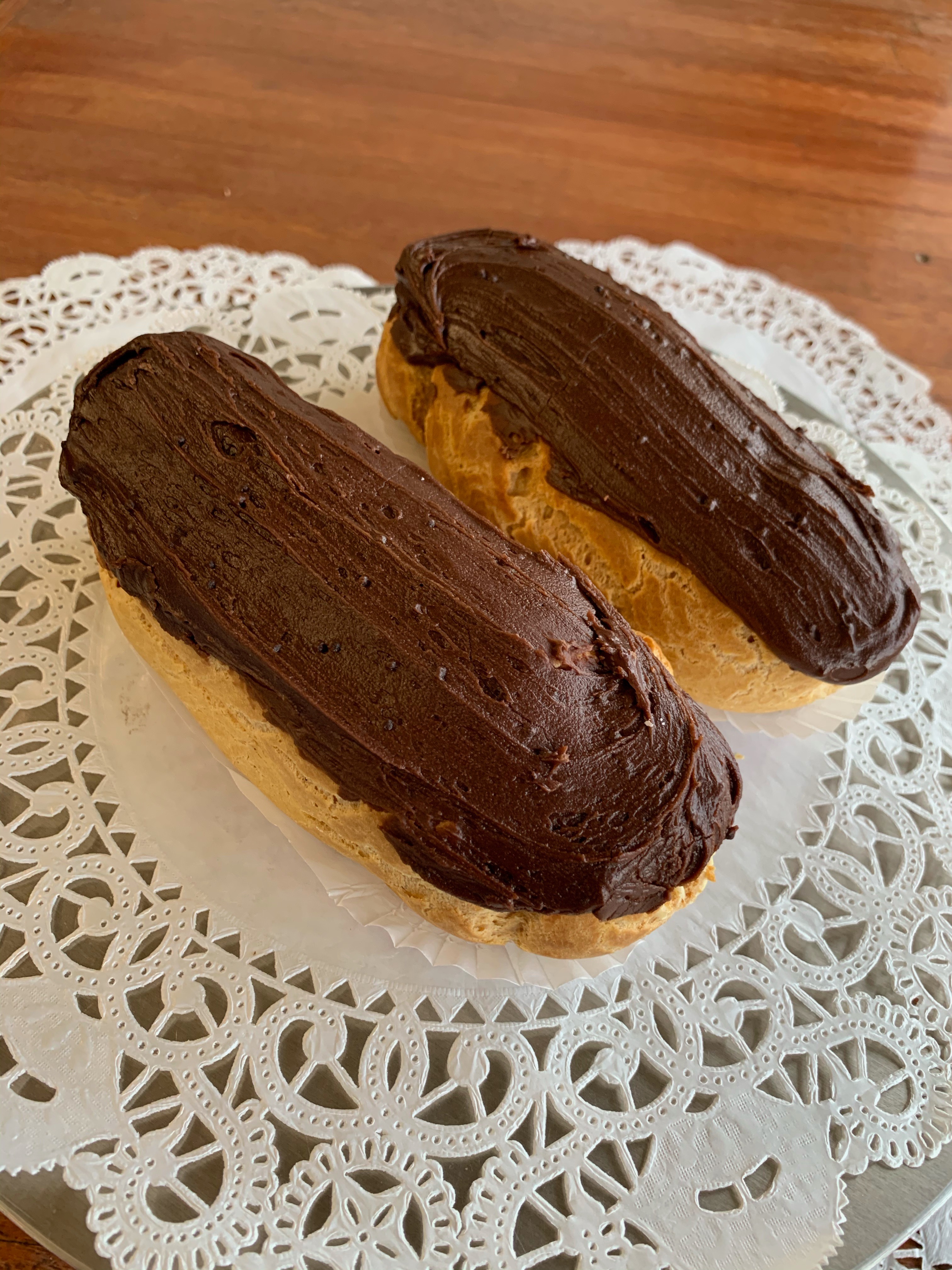 Hand-sized chocolate-topped eclairs filled with house-made custard
