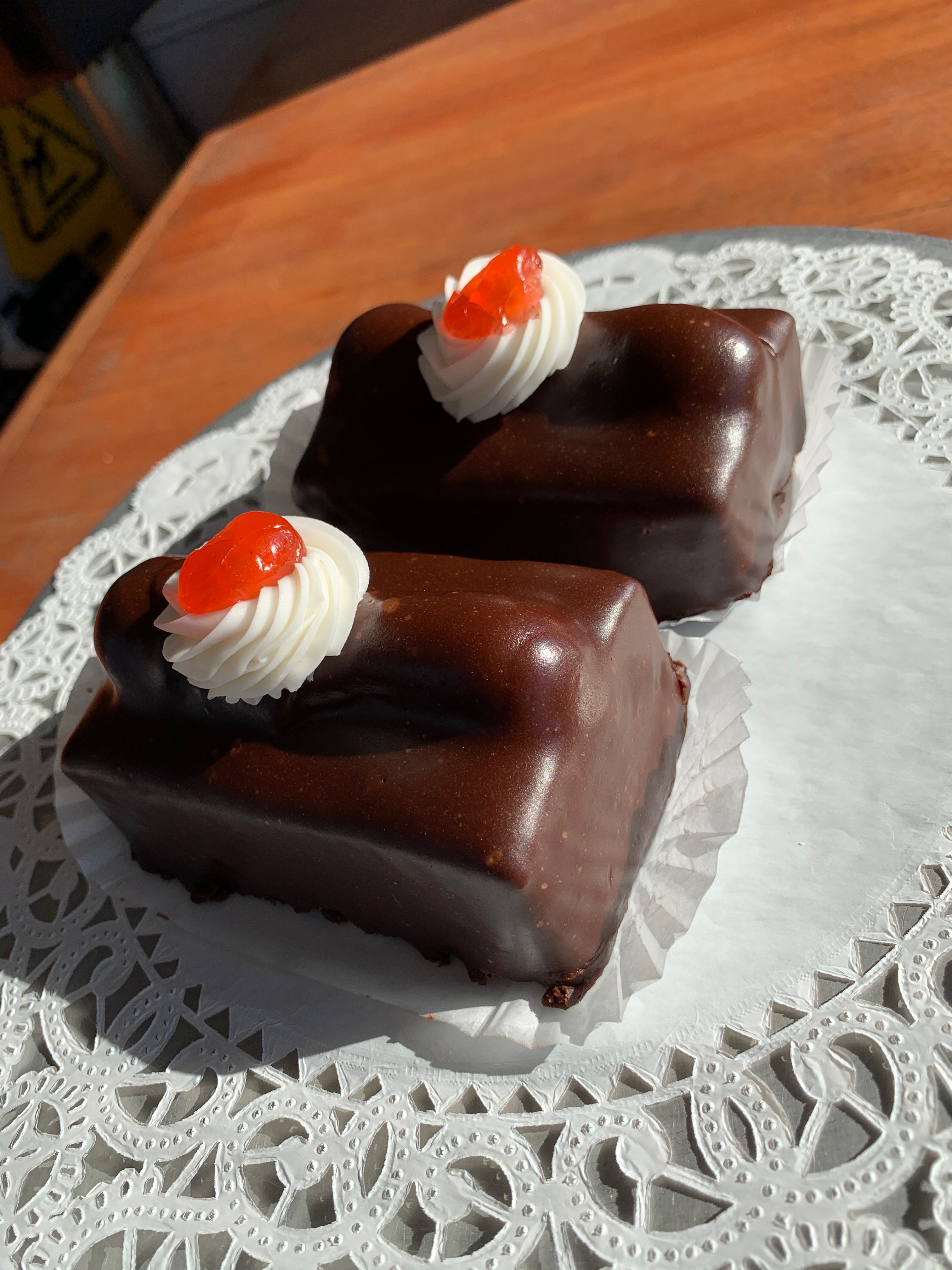 Radio Bars — devil's food cake dipped in chocolate fondant with a buttercream dollop and a cherry